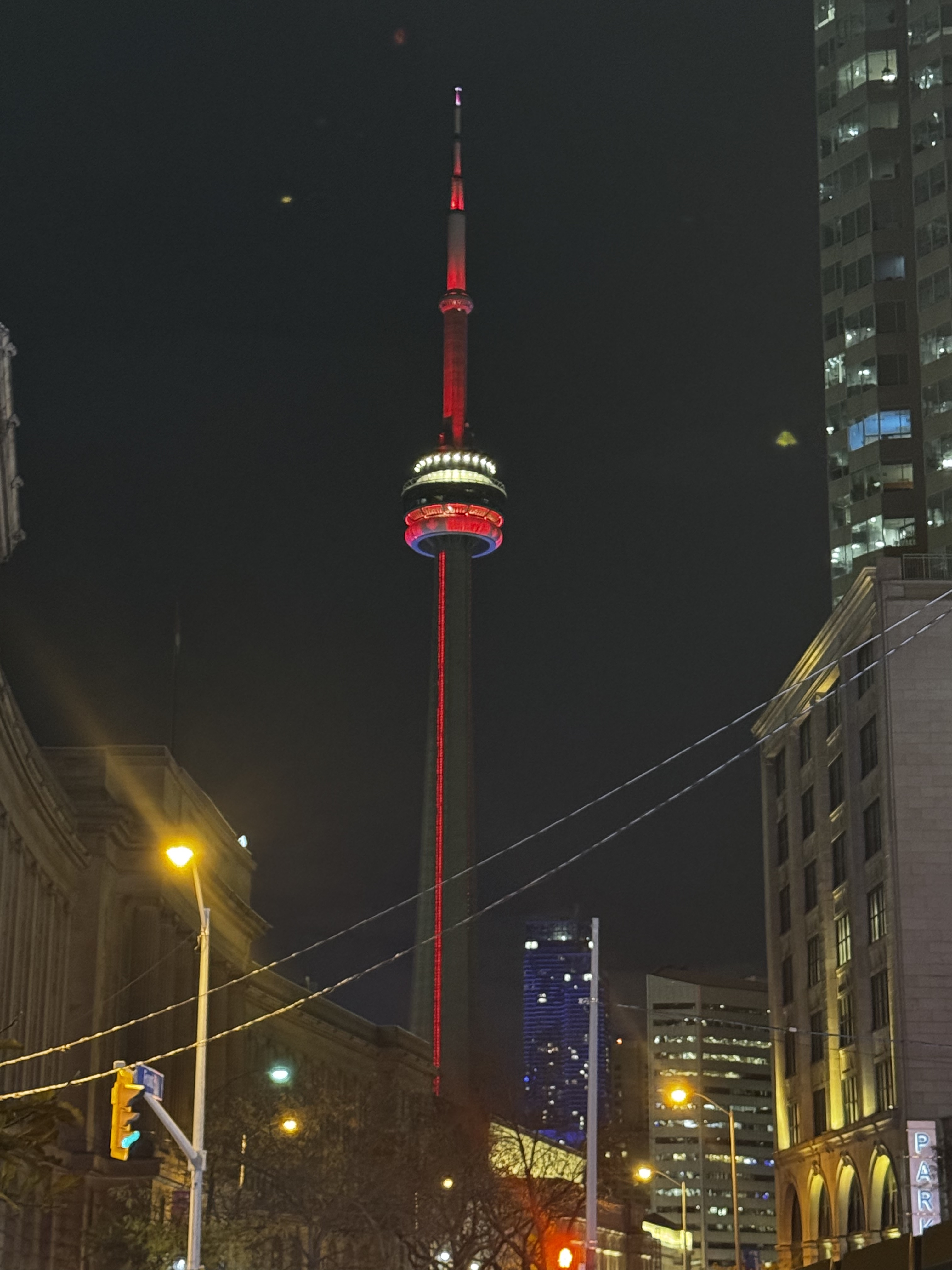 CN Tower lit up in red on November 22, 2025